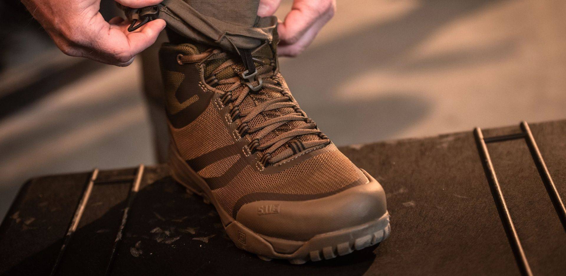 Person tying tactical boots