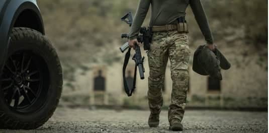 Person wearing tactical boots at shooting range