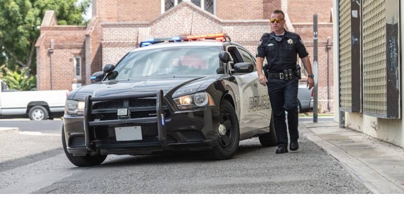 Police Officer in front of Cop Car