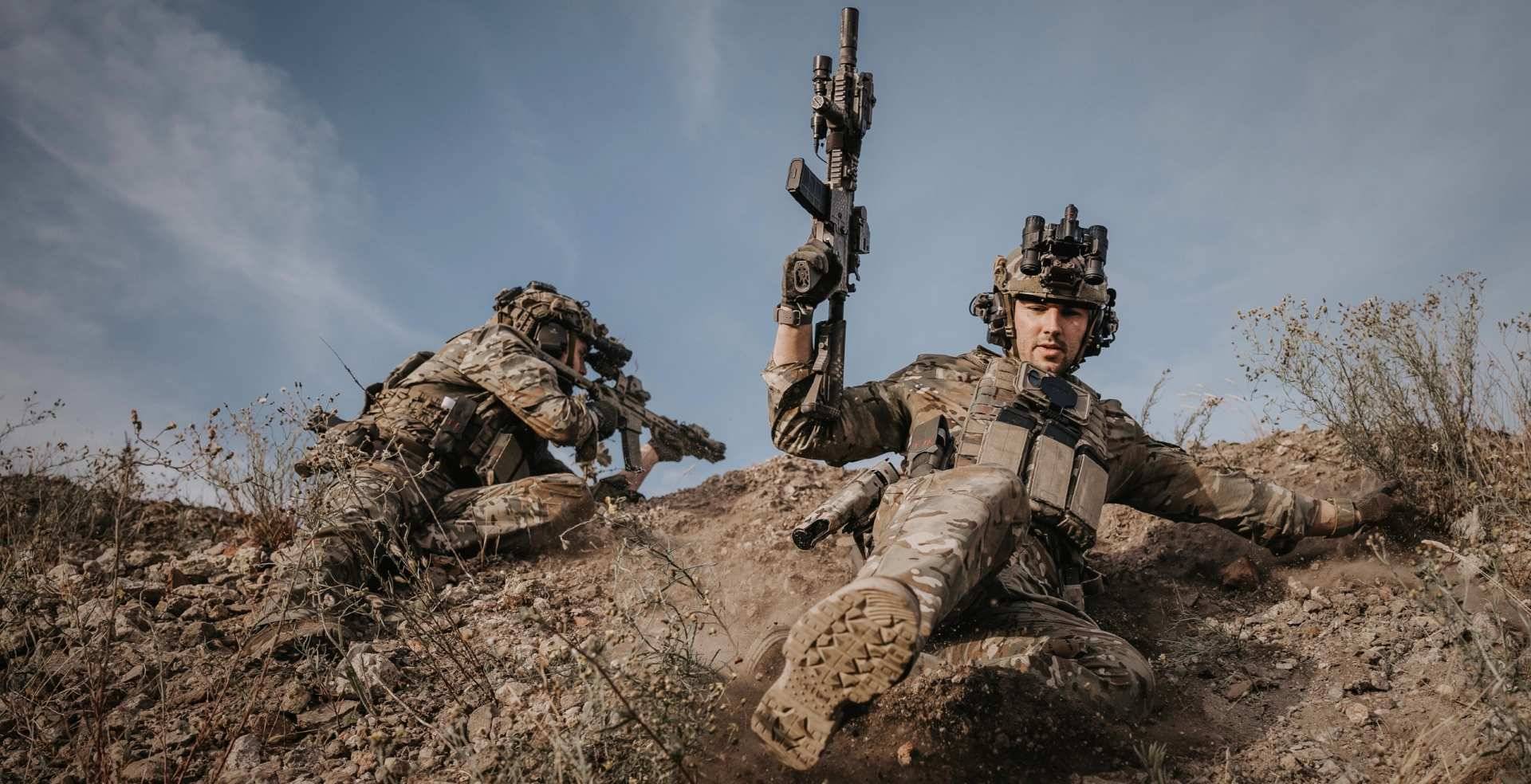 Soldiers wearing tactical boots while taking cover
